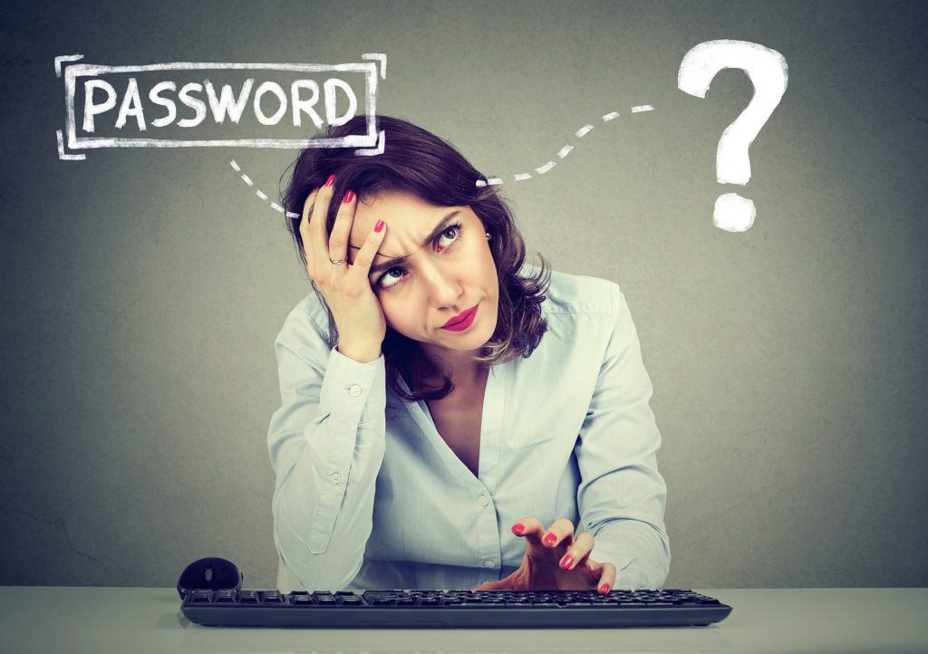 tech frustration: woman puzzled by forgotten password at computer.