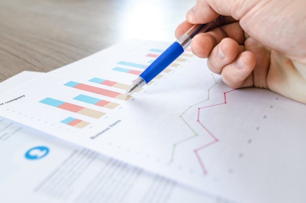 colorful data graphs analyzed with a pen for decision-making in a focused workspace.