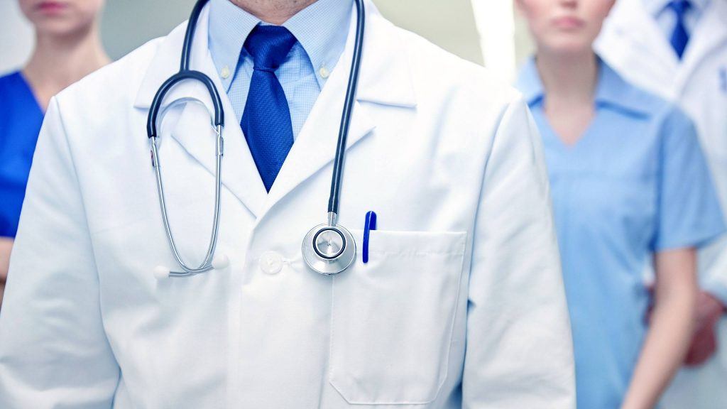 healthcare teamwork led by doctor in white lab coat with stethoscope.