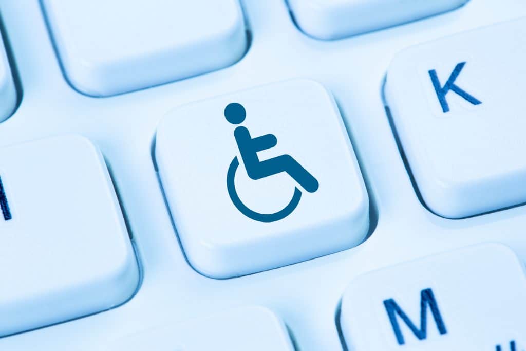 blue wheelchair symbol key promotes inclusivity in modern computer design.