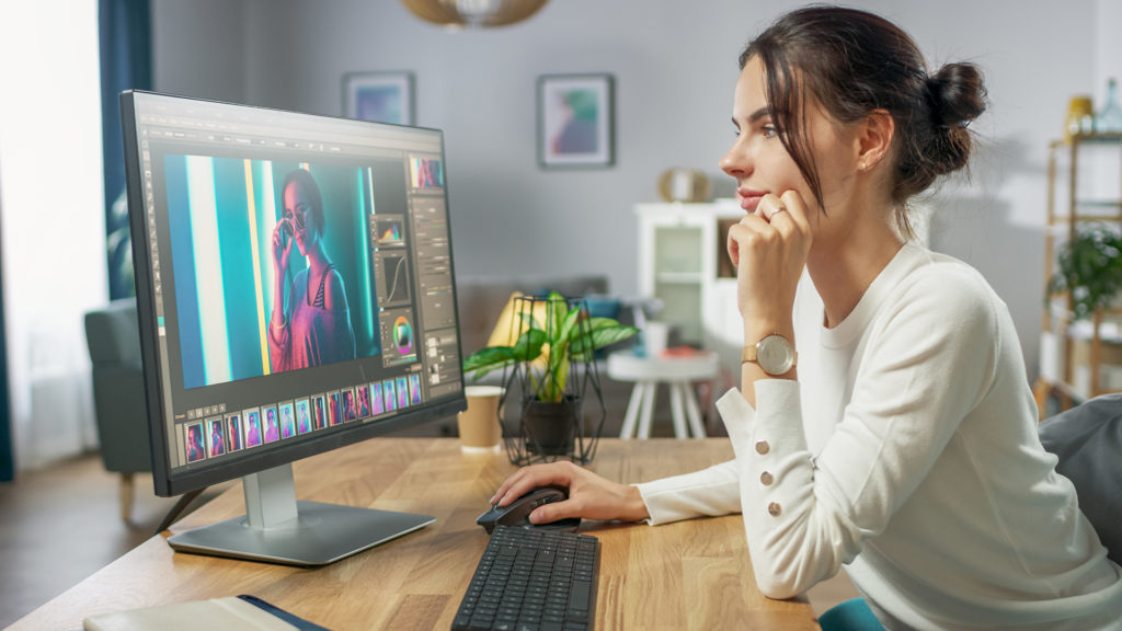 modern workspace with woman editing, surrounded by stylish decor, creating a productive and inspiring environment.