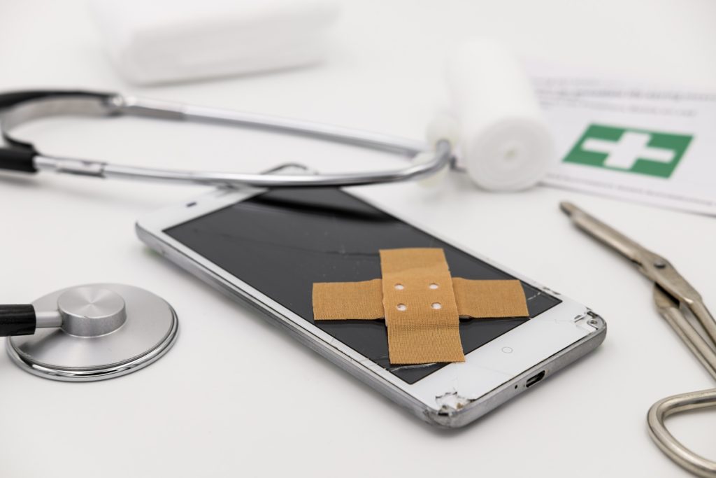 healing tech: smartphone with bandage and stethoscope symbolizing modern healthcare integration.