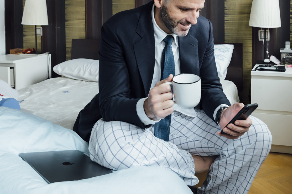 professional in pajamas balancing work and comfort in a modern home office scene.