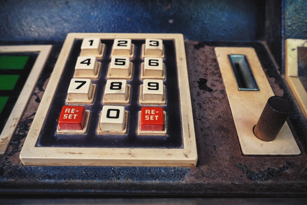 retro keypad with worn numbers and red reset buttons, evoking nostalgia for vintage devices.