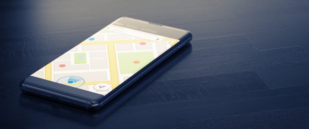 modern smartphone displaying detailed map interface for easy navigation on dark surface.