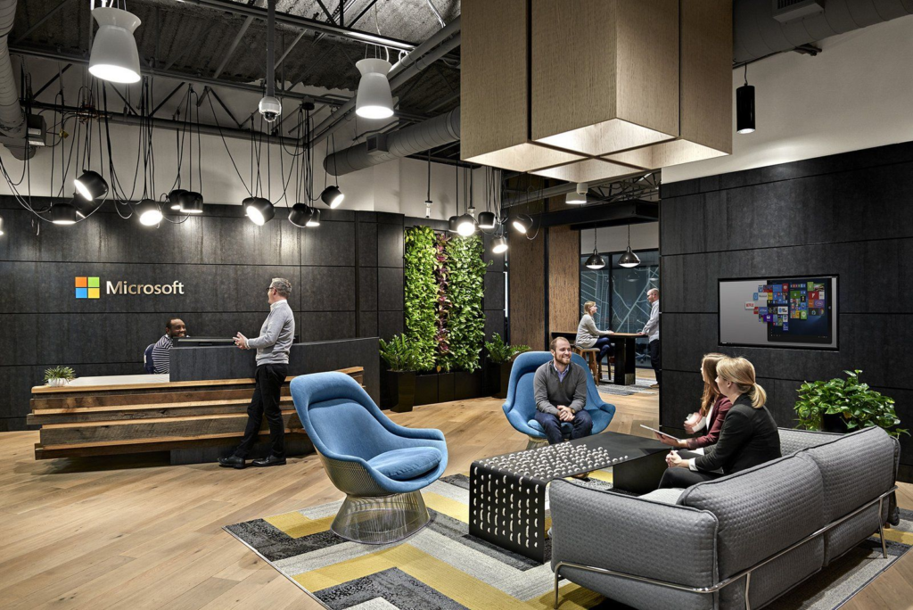 modern microsoft office promoting collaboration and creativity with sleek design, cozy seating, and vibrant decor.