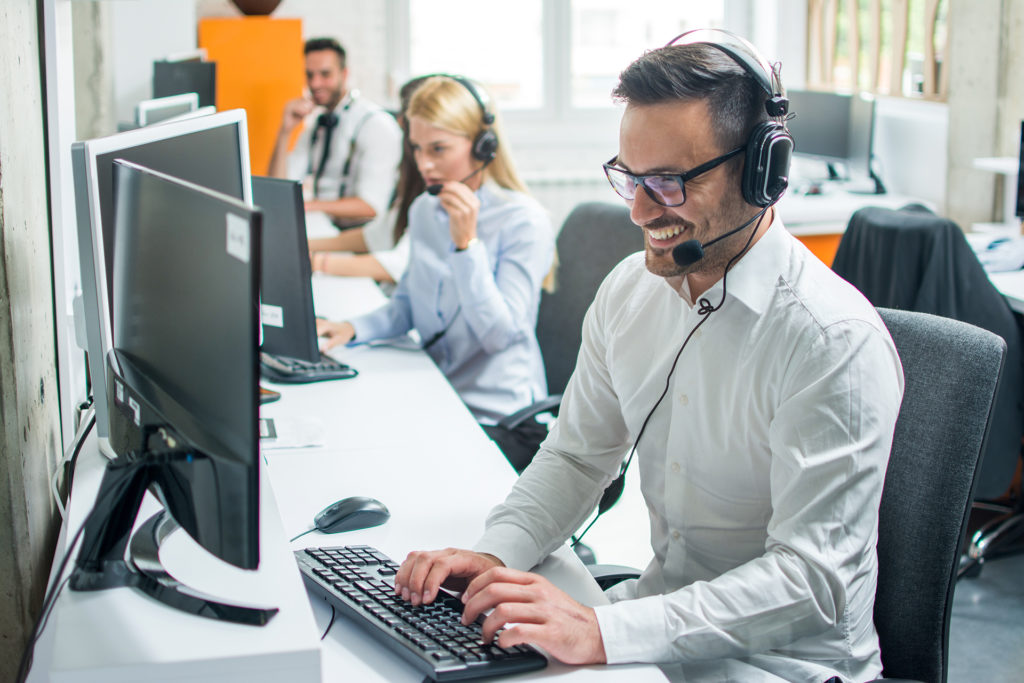 efficient call center team working together in modern, bright office environment.