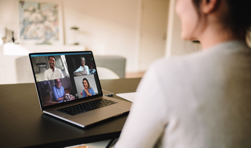 virtual meeting with diverse participants in a cozy, modern home office.