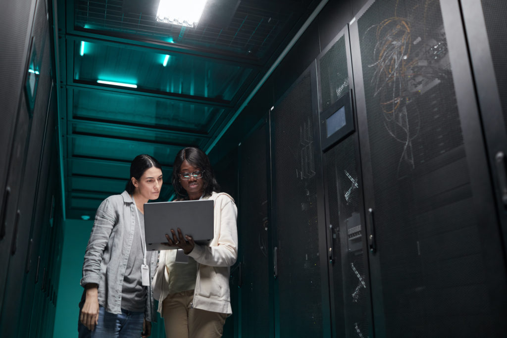 empowering women collaborate in modern data center, managing servers for it innovation.