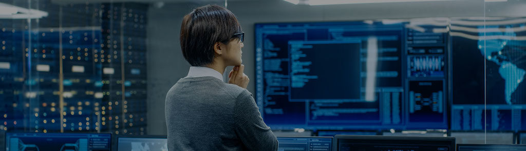 expert analyzing cybersecurity data in high-tech control room with multiple screens.