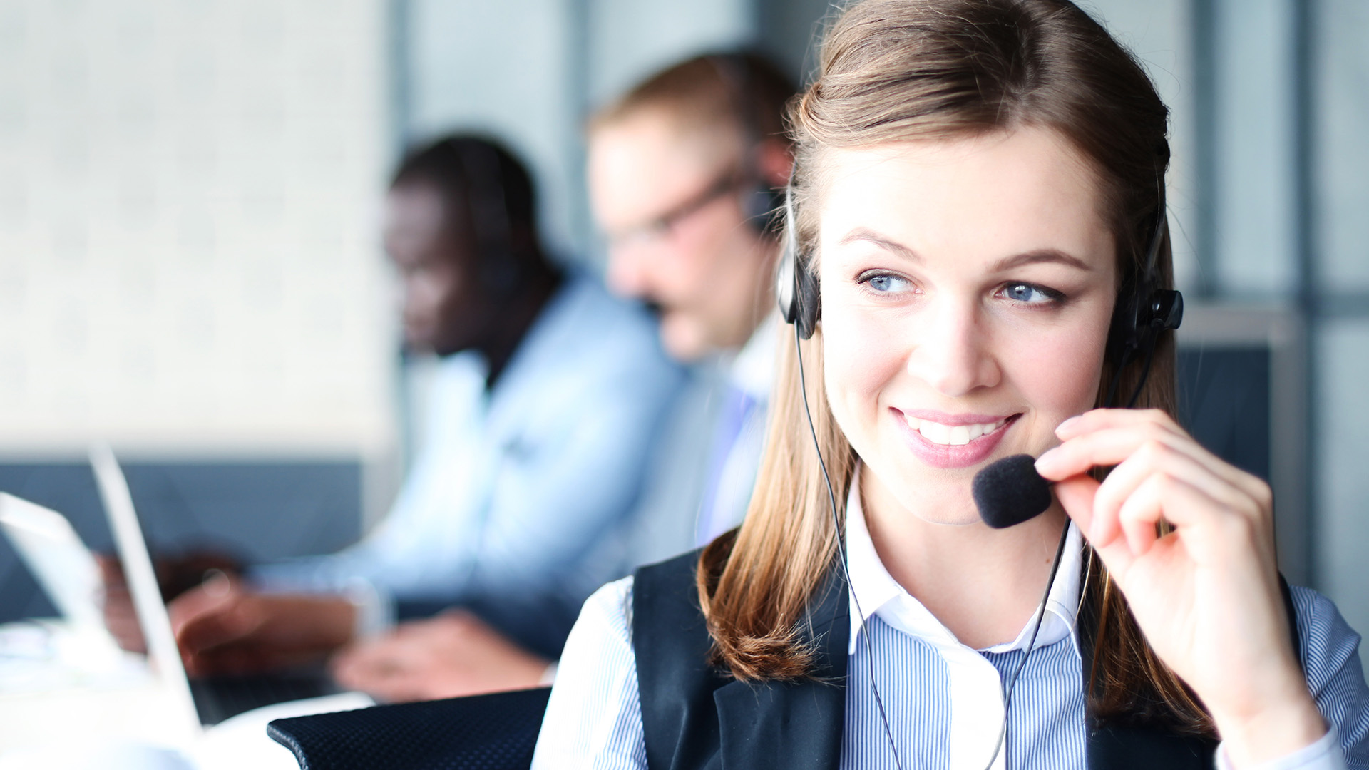 a woman wearing a headset and smiling at the camera