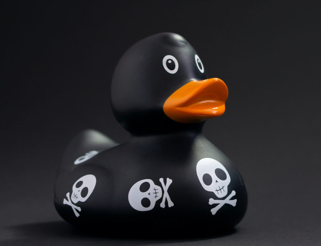 a rubber duck with skulls and bones painted on it