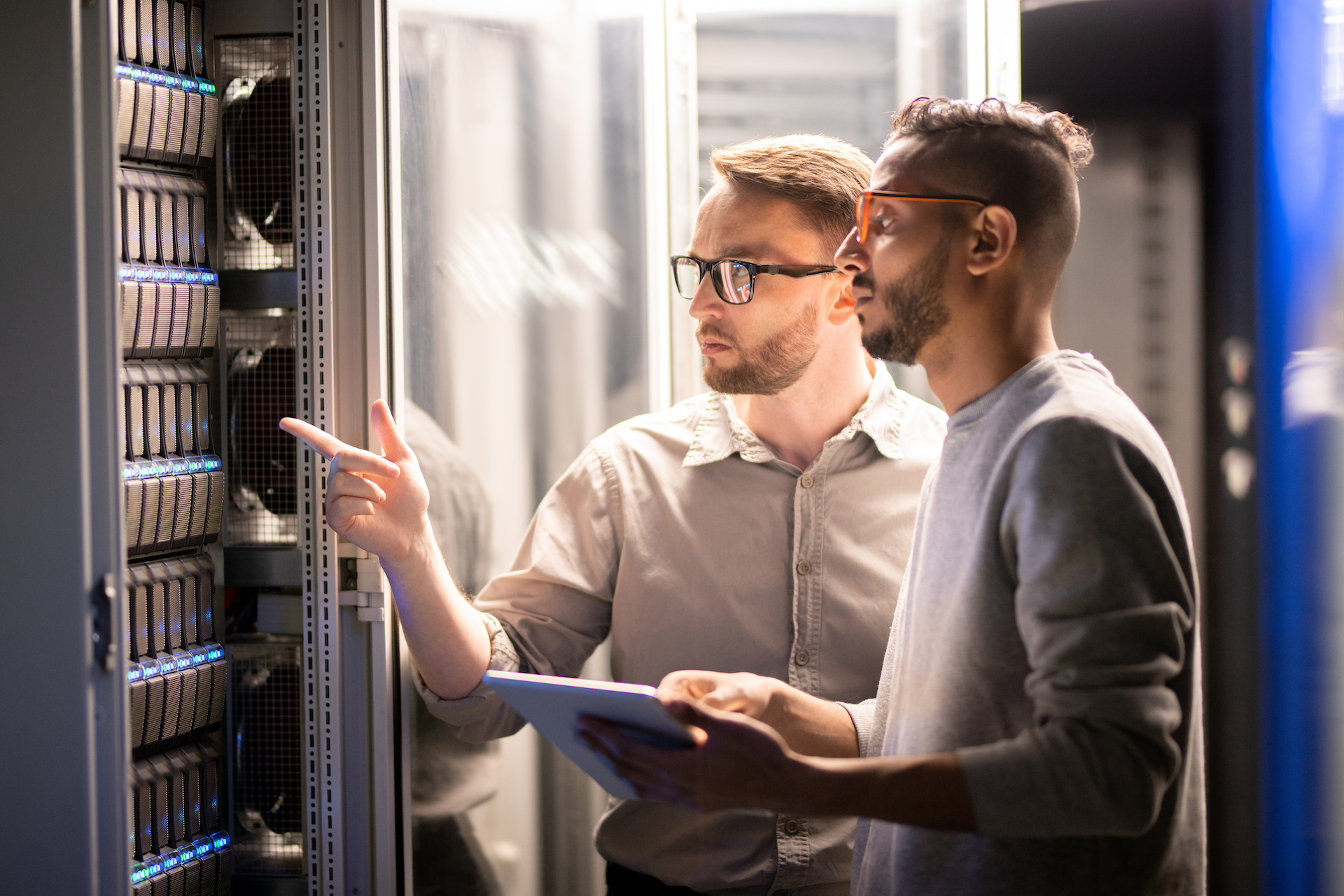 diverse team collaborates in high-tech data center for efficient server management.