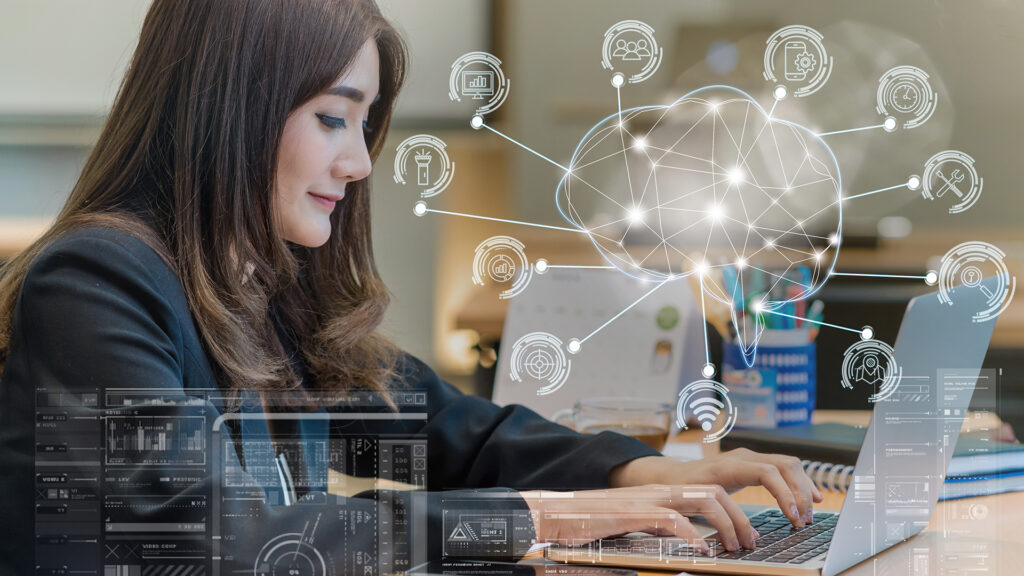 professional woman working on laptop in modern office with digital connectivity.