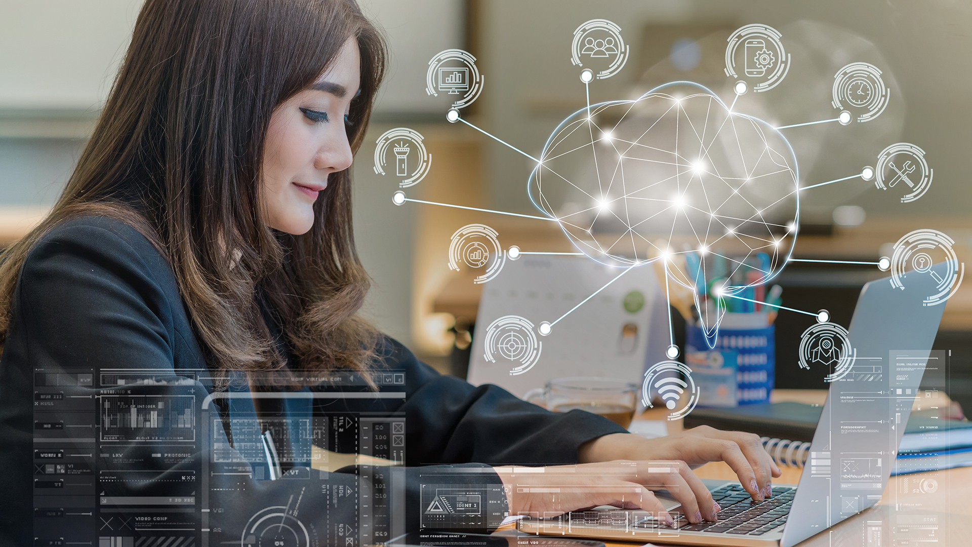 Professional woman working on laptop in modern office with digital connectivity.