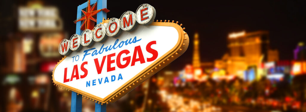 las vegas sign illuminated on strip at night, symbolizing citys excitement and allure.