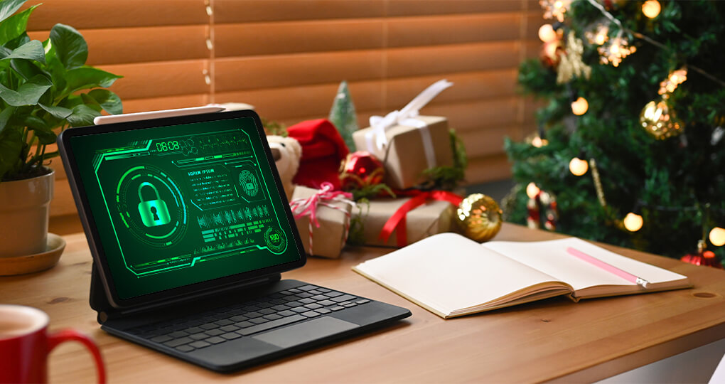 cozy holiday workspace with secure tablet, open notebook, red mug, and festive christmas tree.