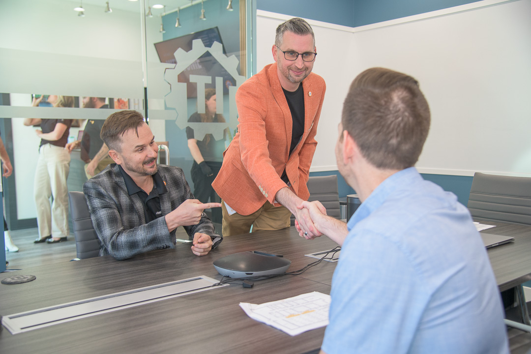 professional business meeting with handshake agreement in modern conference room.