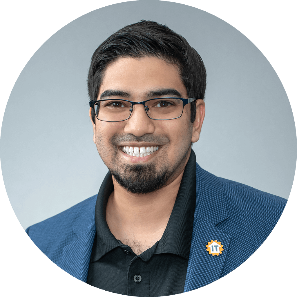 professional young man in smart-casual attire with it pin in headshot portrait.