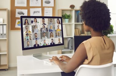 remote collaboration: virtual meeting with diverse participants in modern office setting.